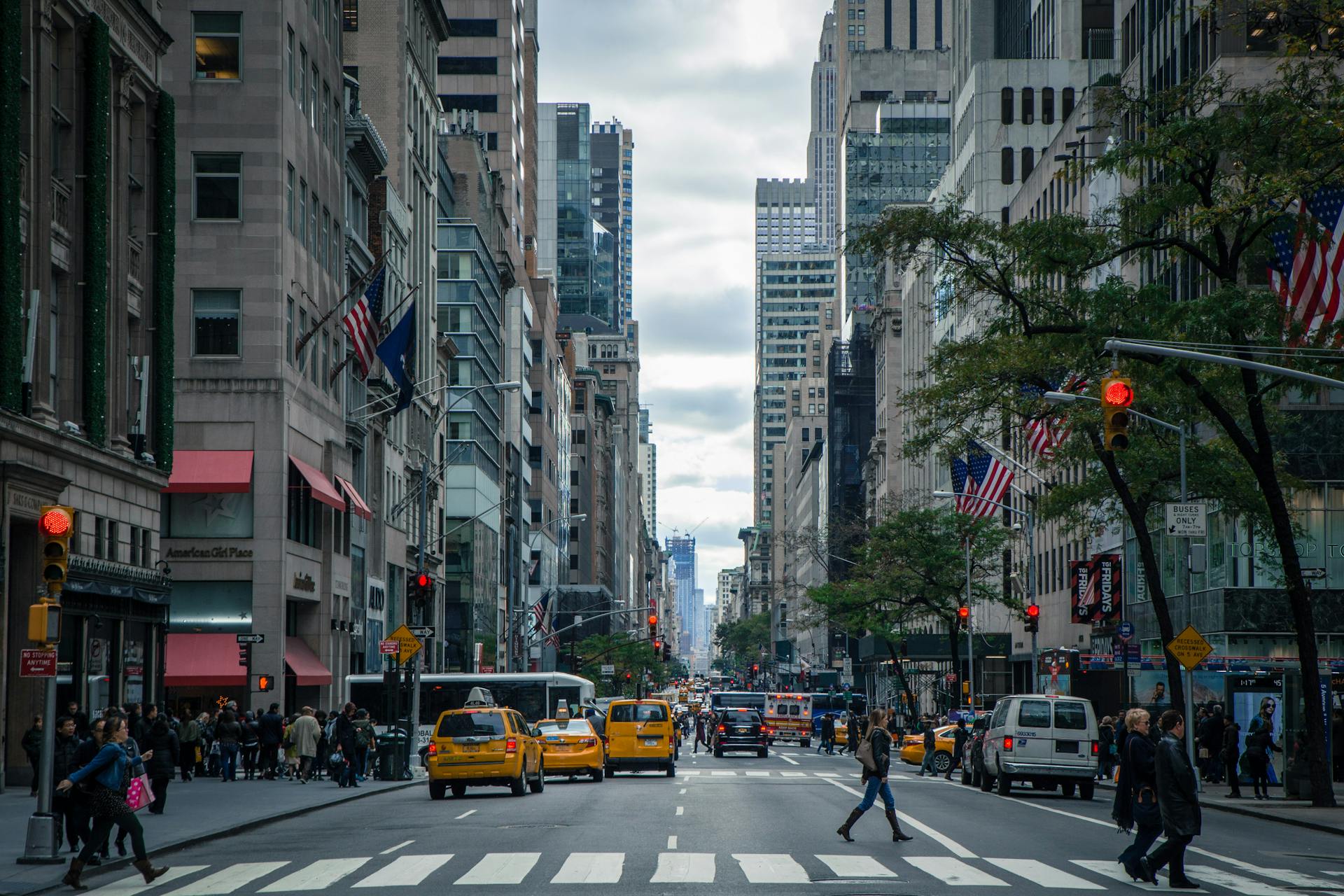 New York City street with yellow taxi cabs and crosswalk, representing car accident legal services